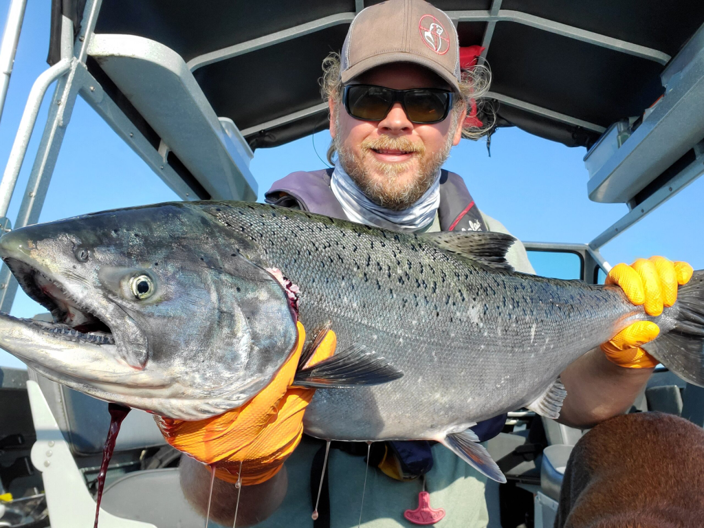 Jerad showing off his Astoria Fishing guide skills with a freshly caught springer
