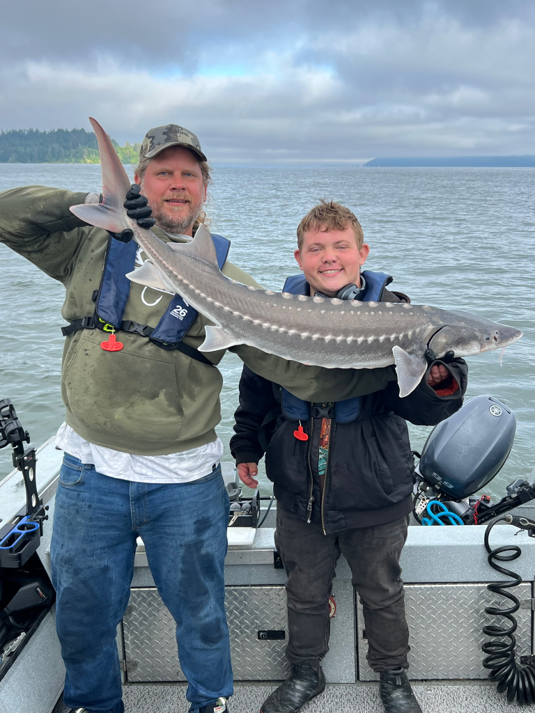 Bobby showing off his first White Sturgeon. This one was small enough to show off