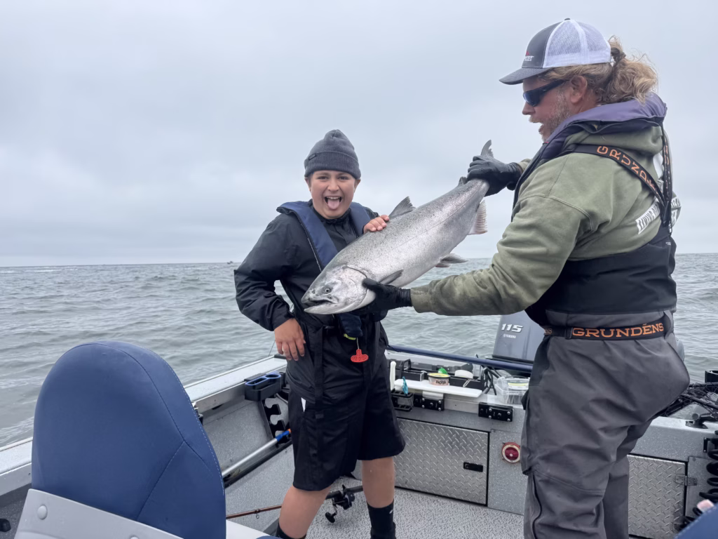 Levi showing off his first Columbia River Salmon during an Astoria Oregon salmon fishing charter his dad took him on for his birthday!