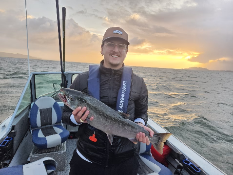 Colin Showing off his first ever Salmon during a late Fall Coho trip