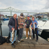 Another happy group showing of their Buoy 10 Salmon Charter catch!
