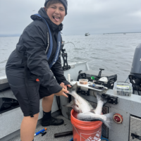 Levi showing off a bucket of freshly caught salmon As part of his birthday Astoria Salmon Fishing Charter during Buoy 10
